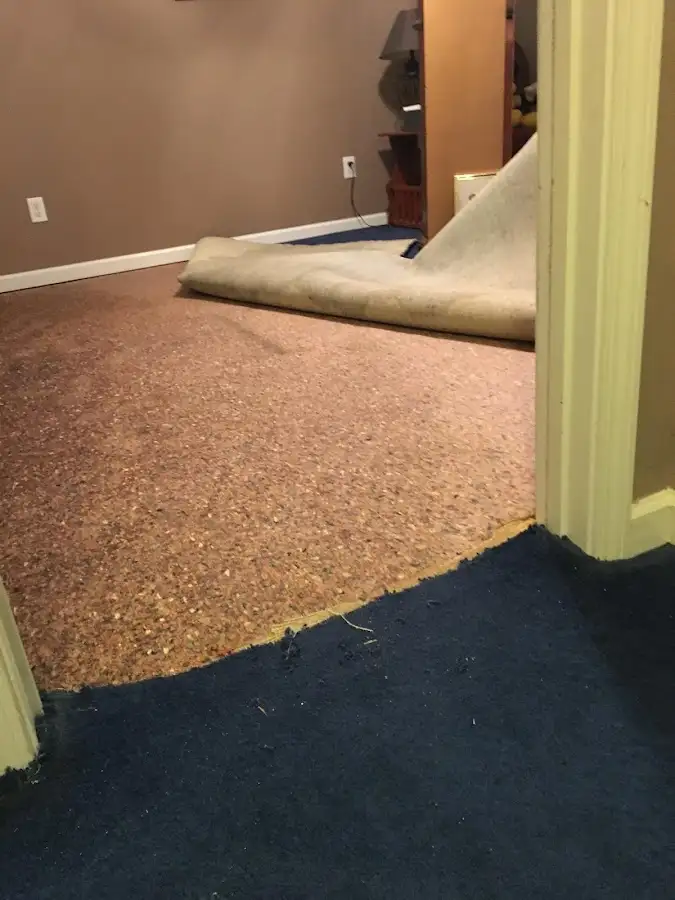Carpet pad removal revealing water damage during Drying & Dehumidification in Kula