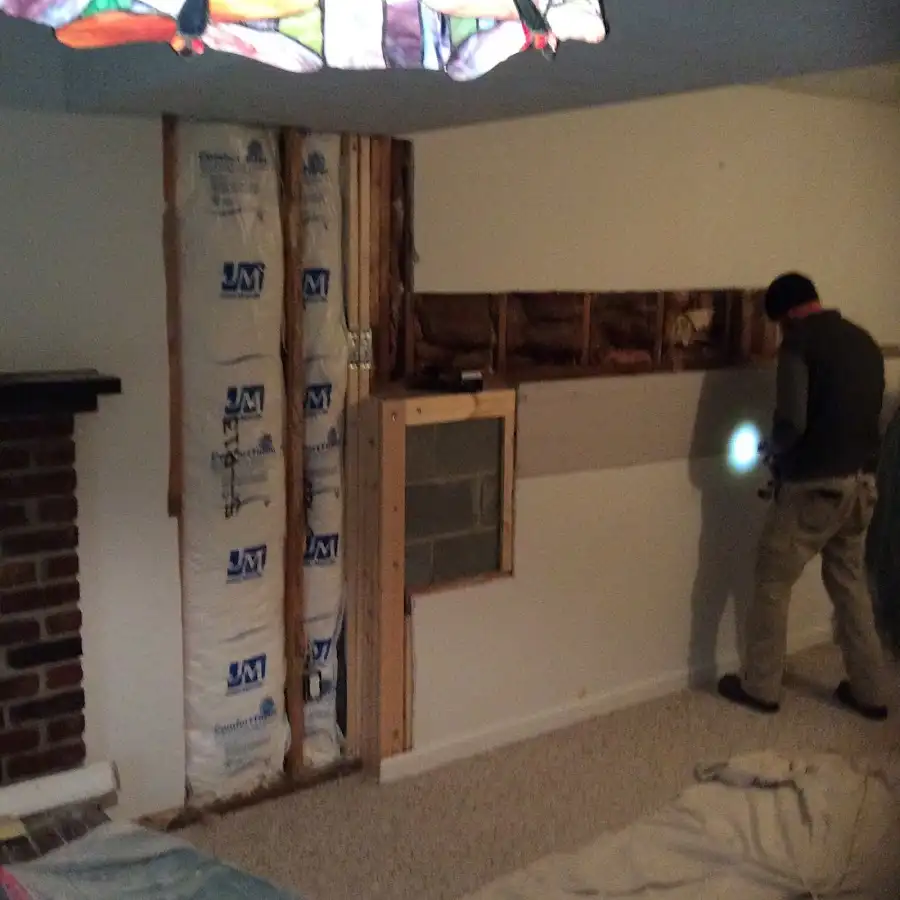 Restoration technician inspecting water damage in Kula